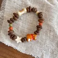 Handmade bracelet with dark roasted coffee beans and ceramic Shiba Inu charm and beads - Multicolor/Puppy Coffee Bean
