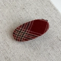 Detail shot of vintage red and black plaid fabric texture on oval hair clip on linen background - Plaid Oval Duckbill Clip / Red