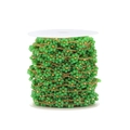 Detail of green crystal beads and gold chain woven flower chain on a white spool - Green