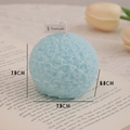Light blue spherical rose scented candle with floral relief on an open book background - Macaron Lake Blue Floral Ball (Rosemary Mint)