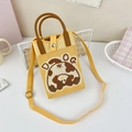 Close-up of yellow knitted crossbody bag with a cartoon cow pattern and leather handle - 22-Yellow Cow