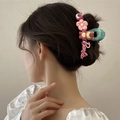 Green plush hair claw clip featuring pink Lotso bear and Barbie logo on low bun hairstyle - Pink Green Cartoon Plush(FJ066)