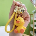 Yellow cartoon resin duck keychain with textured surface, leather strap, and golden bell - Yellow Duck