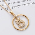 Close-up of golden stainless steel necklace with sparkling zircon number 5 pendant - Gold Number 5