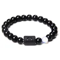Detailed macro of Libra obsidian bracelet featuring matte zodiac bead and luminous stone - Libra