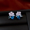 Close-up of vintage flower earrings with blue crystal drops on black leather stand - 9# Silver Earring Post - Silver - Blue - Flower Square Crystal
