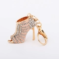 Close-up of sparkling rhinestone high heel keychain with pink enamel and gold finish - Pink