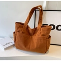Dettaglio della borsa tote in velluto a coste caramello con texture a righe e tasche - Marrone