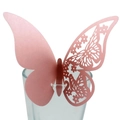 Pink laser-cut butterfly place cards for wedding glasses on a plain background - Pink