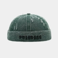 Dettaglio del cappello docker verde vintage con ricamo PROGRESS e finiture in denim lavato - Regolabile / Verde Scuro