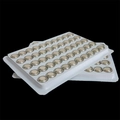 Pack of 100 silver button cell batteries organized in two plastic trays on dark background - AG13 Button Battery (50 Pieces)