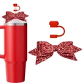 Macro view of red glitter bow accessory and matching silicone straw cap for tumbler - Red