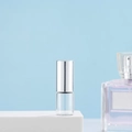 Transparent glass perfume roller bottle with silver cap on a professional white platform - 2ml Silver
