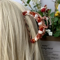 Rose gold hair claw clip with reddish-brown stones and white pearls on blonde hair - Red Agate + Deep Sea Pearl Rose Gold Hair Claw