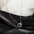 Silver interlocking double ring necklace with roman numerals and sparkling crystals - Roman Numeral Double Ring Style (8893) / Silver