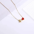 Detail of gold chain necklace with red heart and K letter pendants on white stand - Heart Letter Necklace K