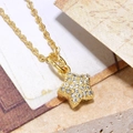 Macro shot of gold star pendant with inlaid cubic zirconia on a delicate link chain - Gold Eight-Pointed Star Pendant (ZYN-DMK637G-A5)