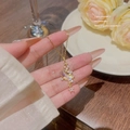 18K gold plated celestial moon and star necklace with iridescent crystal on woman's hand - X093 Gold Star Moon Zirconia