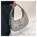 Detailed view of silver crescent bag with metallic crinkled texture and dual zippers - Silver