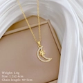 Macro shot of gold crescent moon and star necklace with cubic zirconia on elegant fabric - Star Moon Zircon Style (E347)