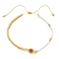 Detail of red gemstone beaded bracelet with adjustable gold beads and cord - Red