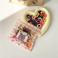 Small colorful elastic hair bands for kids in a heart-shaped ceramic bowl - Vibrant Multi-color