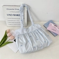 Detailed shot of blue and white striped tote bag featuring small bows and ruffles - Blue Stripe Blue Bow