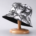 Detail of printed bucket hat with black palm tree patterns on a wooden stand - One Size / Black and White Coconut Tree
