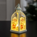 Close-up of white Christmas lantern with Santa Claus illustration and warm LED light - Santa Claus
