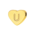 Macro view of gold heart charm with letter U engraving for DIY jewelry making - Letter U