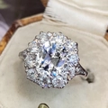 Luxurious halo ring with oval sapphire-style center stone and silver plating - Size 7 / White