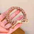 Elastic satin scrunchie in champagne gold featuring a beige bow with yellow beads - Khaki Crystal Decor Scrunchie 1Pc
