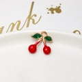 Detail of a cherry pendant with red enamel and green leaves on a white porcelain plate - 19# 3D Cherry