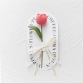 Close-up of a handmade pink crochet tulip with ribbon and elegant gift card packaging - Bulb Tulip - Dark Pink