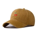 Detail of vintage washed cotton baseball cap with embroidered cherry on mustard fabric - Yellow