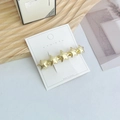 Elegant gold geometric star hair clip on white display card with minimalist background - Star Gold