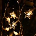Outdoor warm light star-shaped LED string lights wrapped on a metal railing at night - Small Stars / 3m 20-LED Battery Powered / Warm Tone