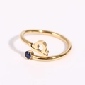 Detail of gold Libra zodiac ring featuring a blue round gemstone and open band design - Libra - Gold