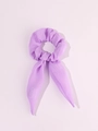 Detailed view of light purple LED hair scrunchie with long ribbons on pink background - Lighted Rabbit Ears-Purple