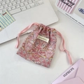 Close-up of floral drawstring pouch with pink bird patterns and woven cord closure - Strawberry Bird