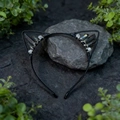 Detailed shot of bohemian black cat ear headband with dark quartz crystals on stone - Black Plated Multi Cat Ears