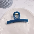 Top view of deep blue glossy hair claw clip with golden spring on ceramic tray - Azure Blue - Butterfly Buckle Straight (Approx 11.3cm)