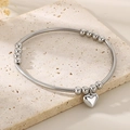 Polished silver metal bead bracelet featuring a heart pendant on a stone surface - Steel Color (KB206158-Z)