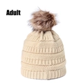 Close-up of beige knit beanie with thick ribbing and large brown faux fur pom-pom - Off White