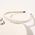 Detailed view of elegant pearl headband with gold metal base and black comfort tips - Full Flowers Small Pearls