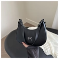 Close-up of black leather crescent bag featuring a silver bow detail and sleek design - Black