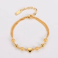 Detalle de pulsera dorada 18KGP con colgante de corazón y cierre de langosta pulido - Dorado