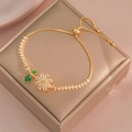 Golden sunflower bracelet with clear zircon and green leaves on jewelry box - Gold Sunflower Bracelet (TS0236)