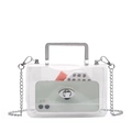 Detail view of clear PVC handbag with silver metal handle and chain strap on white background - Clear/Silver Hardware