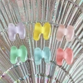 Macro shot of colorful translucent resin bow accessories for hair clips and DIY crafts - Letter H